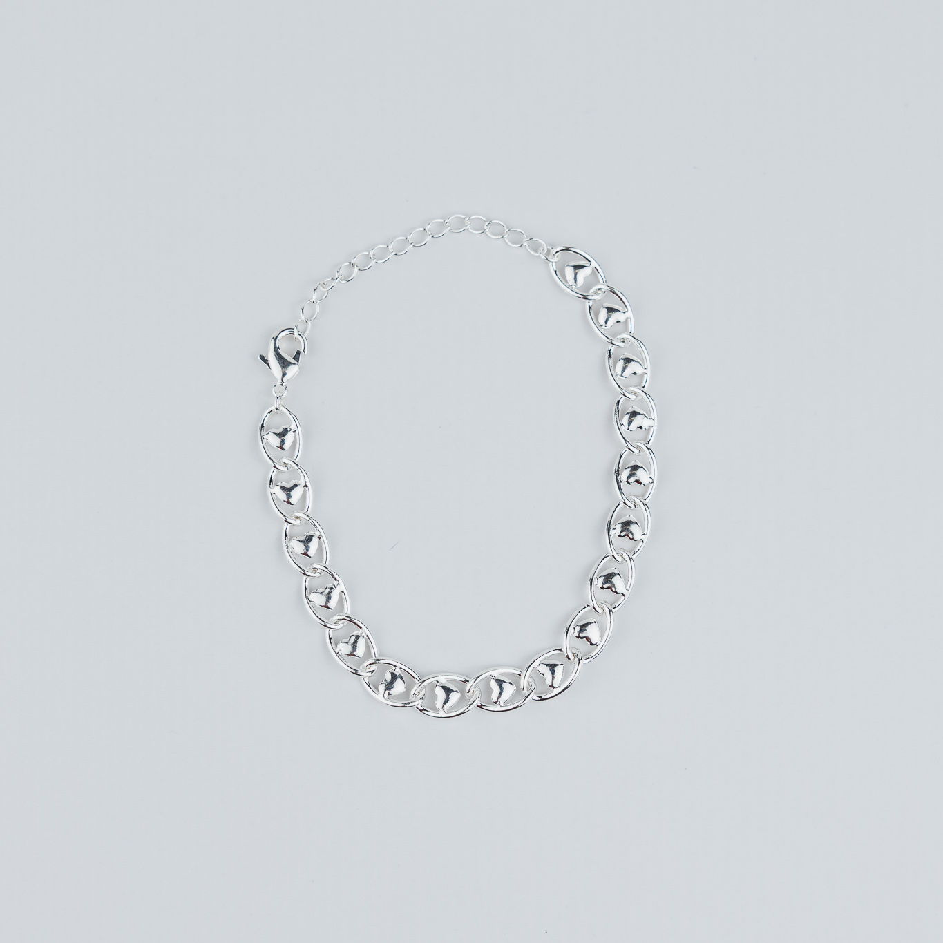 BRACCIALE A MAGLIE CON CUORE AL CENTRO